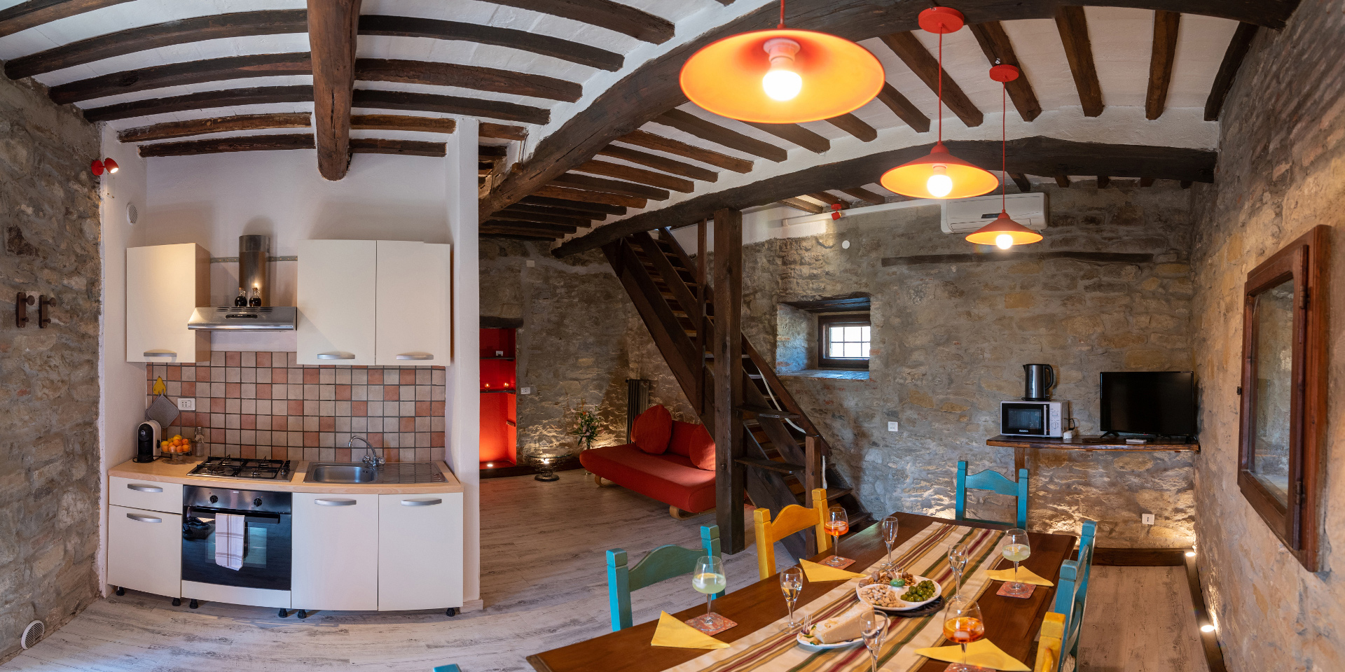 The panoramic photo shows the living room and the kitchen in Ilva Apartment,
								Monastero San Silvestro